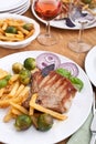 Pork chops with fries, brussels sprouts and wine