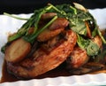 Pork chops with mushroom gravy spinach and potatoes on white plate Royalty Free Stock Photo