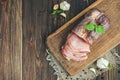 Pork dried meat slices on rustic dark wooden background Royalty Free Stock Photo