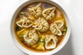 Pork dumplings in soup on white background, top view