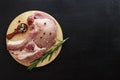 Pork entrecote with rosemary and a spoon with pepper on a wooden stand. View top copy space
