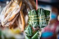 Pork fermented pork wrapped in banana leaves hung on carts selling papaya salad
