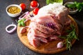 Pork fillet on a cutting board, raw meat, assorted minced pork and beef and various spices on a stone or slate background.