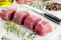 Pork fillet. Raw meat with spices on cutting board.