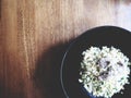 This is pork fried rice on black plate above wooden desk, soft t