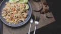 Pork fried rice is a common street food in Thailand. Served on a black wooden table Royalty Free Stock Photo