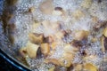 Pork greaves scraps boiling in grease in big metal pot Royalty Free Stock Photo