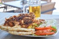 Pork gyros on a plate with salad and a bear Royalty Free Stock Photo