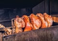 Pork ham meat is roasted on an open fire in the grill. Street Czech food. Prague, Czech Republic Royalty Free Stock Photo