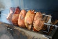 Pork ham meat is roasted on the open fire. Street Czech food in the grill. Royalty Free Stock Photo