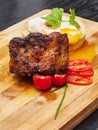 Pork Joint served with baby tomators and egg on wooden board