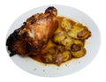 Pork knuckle baked in oven with boiled potatoes in white plate