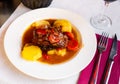 Pork knuckle with potatoes and stewed bell peppers closeup Royalty Free Stock Photo