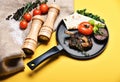 Pork or lamb ribs with decor on frying pan Royalty Free Stock Photo