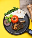 Pork or lamb ribs with decor on frying pan Royalty Free Stock Photo