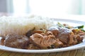 Pork leg stewed with rice on plate