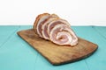 Pork meat roulade sliced on a wood chopping board, side view Royalty Free Stock Photo