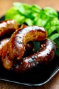 Pork meat sausages on a black plate Royalty Free Stock Photo