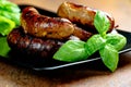 Pork meat sausages on a black plate Royalty Free Stock Photo