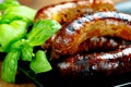 Pork meat sausages on a black plate Royalty Free Stock Photo