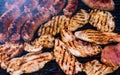 Pork meat and sausages grilled on a charcoal barbeque. Top view of tasty barbecue, food concept, food on grill and detail of food