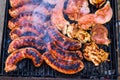 Pork meat and sausages grilled on a charcoal barbeque. Top view of tasty barbecue, food concept, food on grill and detail of food