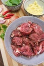 Pork medallions for Vietnamese dish preparation on a wooden board