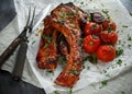 Pork middle chop roast with sweet and sour souce, baked tomatoes and red onion