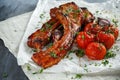 Pork middle chop roast with sweet and sour souce, baked tomatoes and red onion