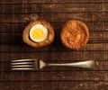 Pork pies on a wooden block with a wooden chopping board background Royalty Free Stock Photo