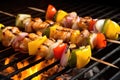 pork and pineapple skewers on a hot coal bbq Royalty Free Stock Photo