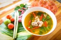 Pork rib spicy soup - pork bone with hot and sour soup bowl with fresh vegetables Tom Yum thai herbs and spices ingredients with Royalty Free Stock Photo