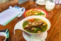 Pork rib spicy soup , pork bone with hot and sour soup bowl with vegetables called Tom-Sabb. one of famous gourmet in Thailand Royalty Free Stock Photo