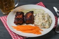 Pork ribs with American potato salad and carrot. The view from the top. Copy-space