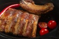 Pork ribs baked with hot pepper and tomatoes, close-up Royalty Free Stock Photo