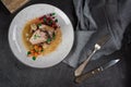 Pork ribs with beets, carrots, fried mushrooms and sauce on a white plate. Restaurant serving. Old black rustic background. Top vi Royalty Free Stock Photo