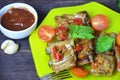 Pork ribs braised with soy sauce and vegetable tomato on the plate Royalty Free Stock Photo