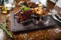 Pork ribs cooked at low temperature. Blackcurrant sauce, parsnip chips with Parmesan cheese. Delicious healthy meat food Royalty Free Stock Photo