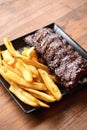 Pork ribs and French fries Royalty Free Stock Photo