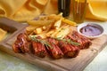 Pork ribs, potato fries and tomato sauce, close up view Royalty Free Stock Photo