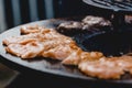 Pork ribs and steak cooked on grill, open fire street food festival