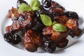 Pork ribs stewed with prunes and basil close-up. Royalty Free Stock Photo