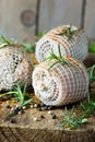 Pork rolls with spices and seasoning on old cutting board Royalty Free Stock Photo