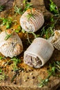 Pork rolls with spices and seasoning on old cutting board Royalty Free Stock Photo