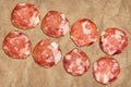 Pork Salami Slices On Crumpled Striped Manila Brown Kraft Paper