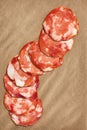 Pork Salami Slices On Crumpled Striped Manila Brown Kraft Paper