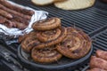 Pork sausage and hot dogs on the grill Royalty Free Stock Photo