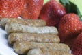 Pork sausage links with strawberries Royalty Free Stock Photo
