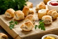 Pork sausage rolls with mustard and ketchup sauce on wooden board Royalty Free Stock Photo