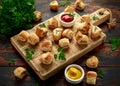 Pork sausage rolls with mustard and ketchup sauce on wooden board Royalty Free Stock Photo